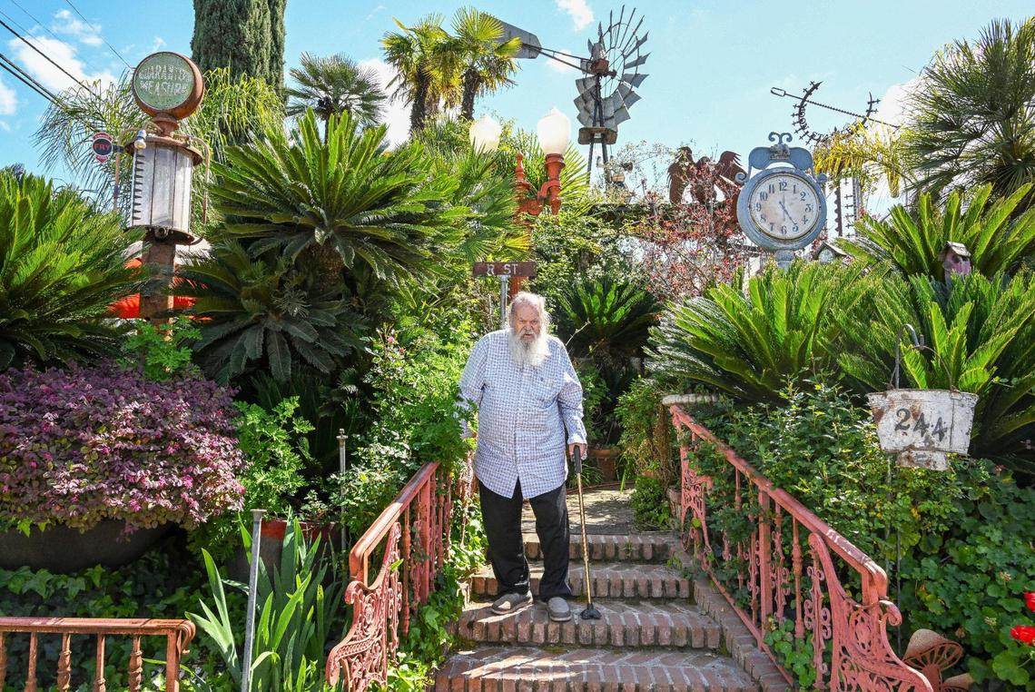 Jim Williams, surrounded by sago palms, old gas pumps, signs, clocks and an old windmill among other collected items and creations, stands on the brick steps leading to the entry of his home in the Fresno High area which he calls “Palazzo Del Sogni,” or Palace of Dreams.