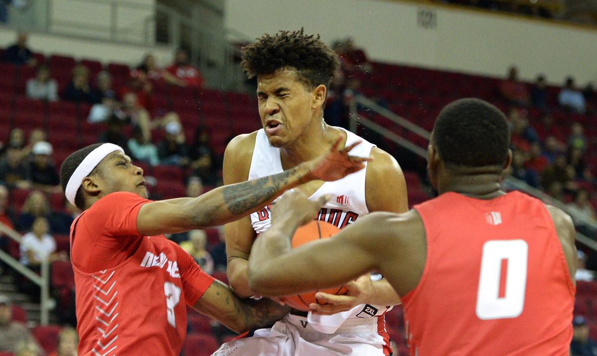 Fresno State freshman Orlando Robinson, center, takes a foul from New Mexico’s Keith McGee as Zane Martin comes in to defend in the Bulldogs’ 82-77 victory over the Lobos at the Save Mart Center in Fresno on Saturday, Feb. 1, 2020. Robinson scored a team-high 20 points with 15 rebounds and three assists and two steals in the win.