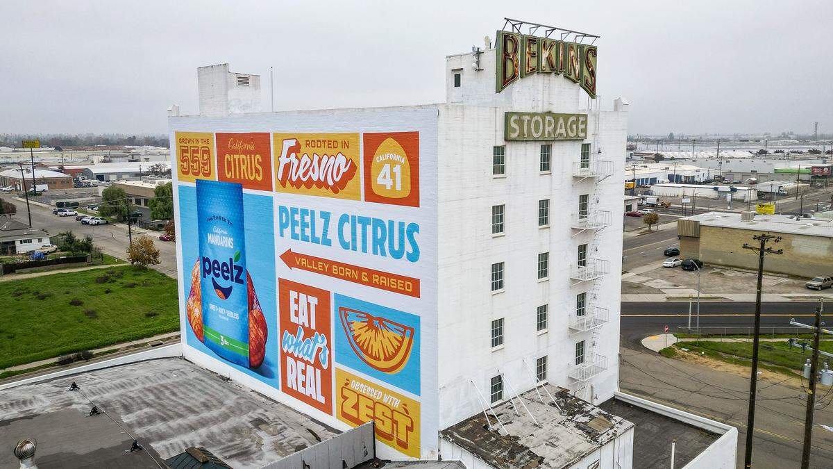 Fresno's historic Bekins building, known for its Peelz Citrus mural visible from Highway 41, has been sold to local developers Reza Assemi and his business partner, Jaime Gonzalez.