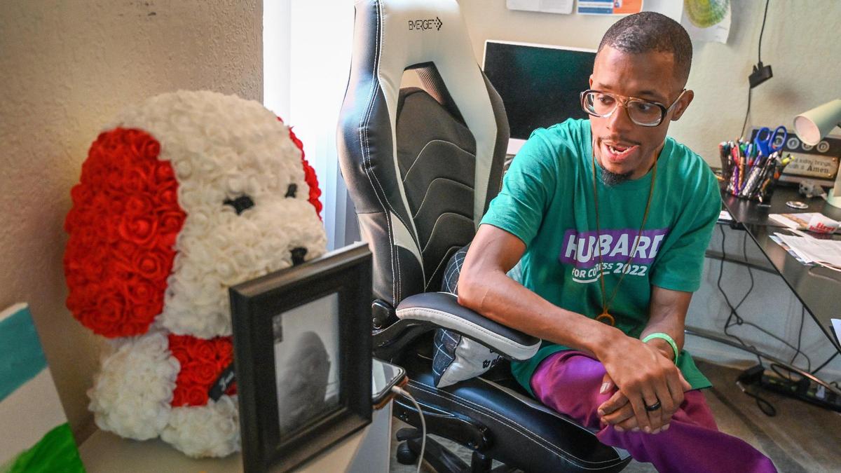 Christopher Washington sits at his desk where he keeps a photo of his mother who recently passed away at his apartment in Fresno on Wednesday, June 9, 2022.