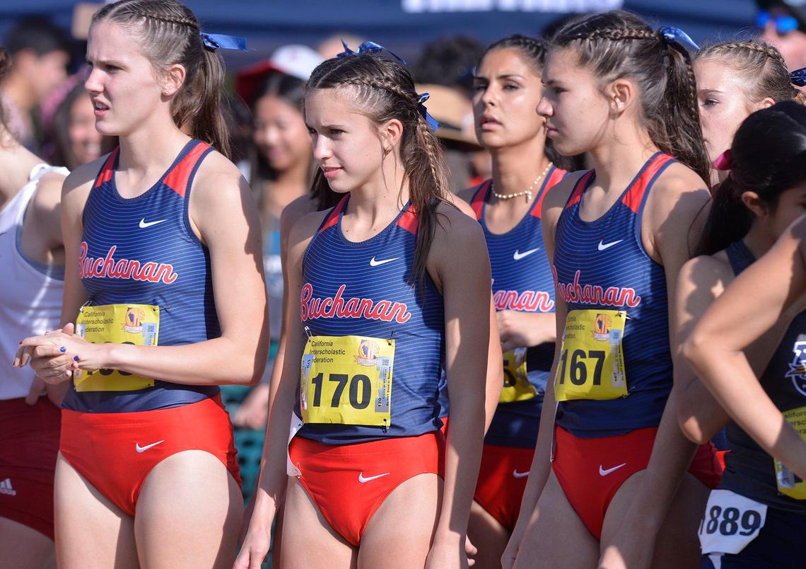 The Buchanan Division I team, including Sydney Sundgren, second from left, prepares to race at the CIF State Cross Country Championships on Saturday, Nov. 27, 2021, at Woodward Park in Fresno. Sundgren placed third overall for the team champion Bears.