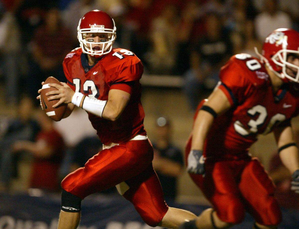 Fresno State's Paul Pinegar rolls out for a pass in the third quarter of the dogs game with Toledo.
