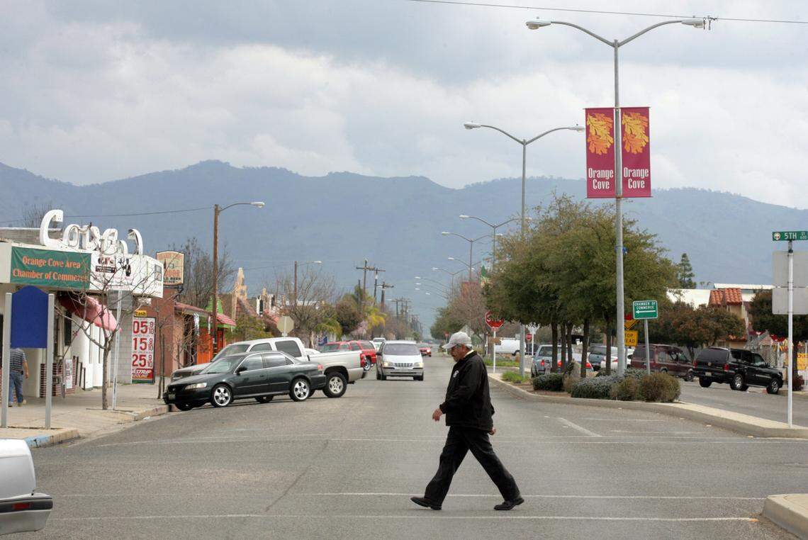 A pedestrian walks across Park Boulevard in central Orange Cove in March 2013.