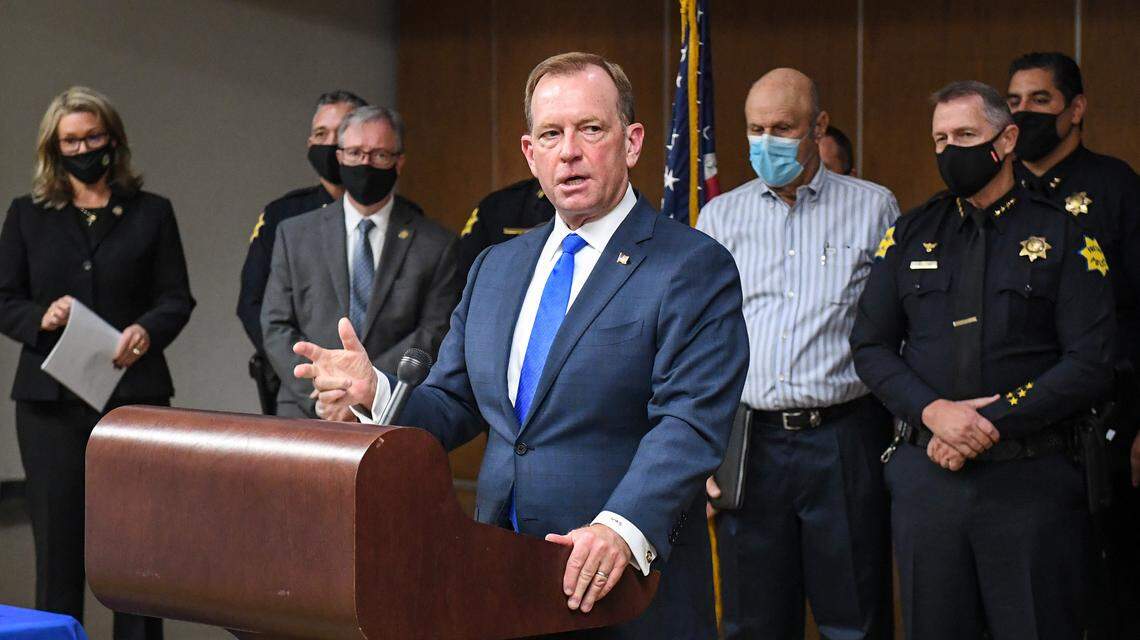 U.S. Attorney McGregor W. Scott, joined by members of various local law enforcement agencies, addresses the media on the recent surge in violent crime, in downtown Fresno on Wednesday, Oct. 21, 2020.