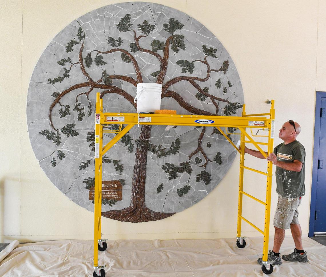 Artist David Roberts prepares to work on a bas-relief and mosaic mural of a valley oak tree made by himself and sixth graders at Manchester GATE Elementary School in Fresno, on Tuesday, June 1, 2021.