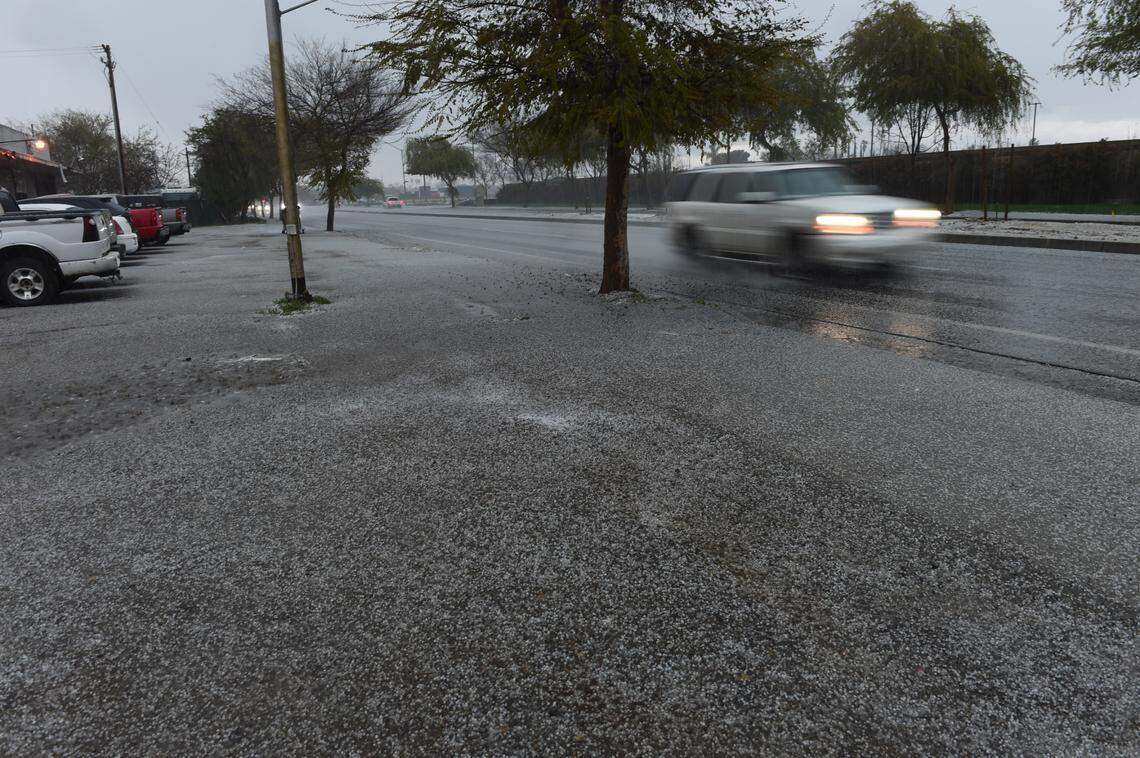 Hail blankets the ground on South Elm Avenue in Fresno during Wednesday’s thunderstorm.