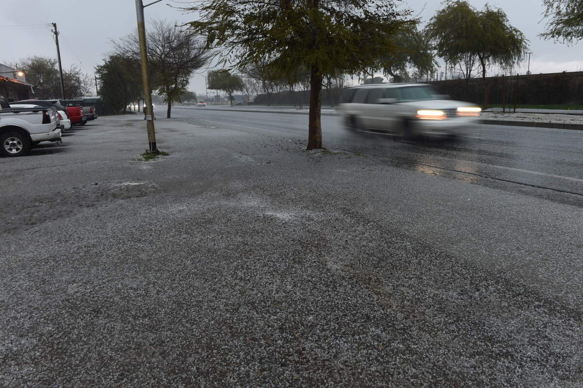 Hail blankets the ground on South Elm Avenue in Fresno during Wednesday’s thunderstorm.