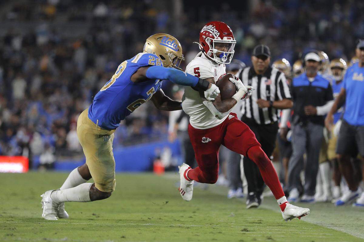 Fresno State wideout Jalen Cropper runs by UCLA defensive back Kenny Churchwell III in the Bulldogs’ 40-37 victory over the Bruins at the Rose Bowl in Pasadena, Sep. 18, 2021.