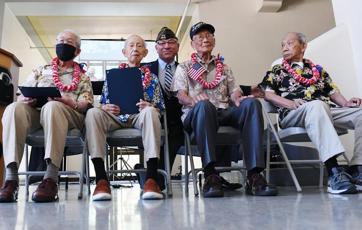 Four Chinese American WWII veterans, seated left to right, Hansen Chin, Wing Tuck Chin, Raymond Lee and Edward Sing Quan, receive medals and recognition in a ceremony attended by about 150 family and supporters at the Veterans Memorial Museum Saturday morning, June 26, 2021 in Fresno.