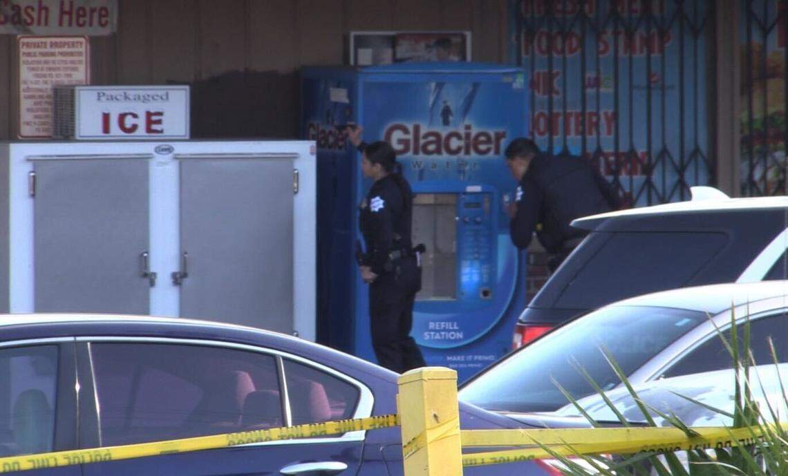 Police investigate the scene after a person was shot Sunday, April 16, 2023, at Zacks Smoke Shop in Fresno, California. Officers pursued the suspect vehicle and detained two people.