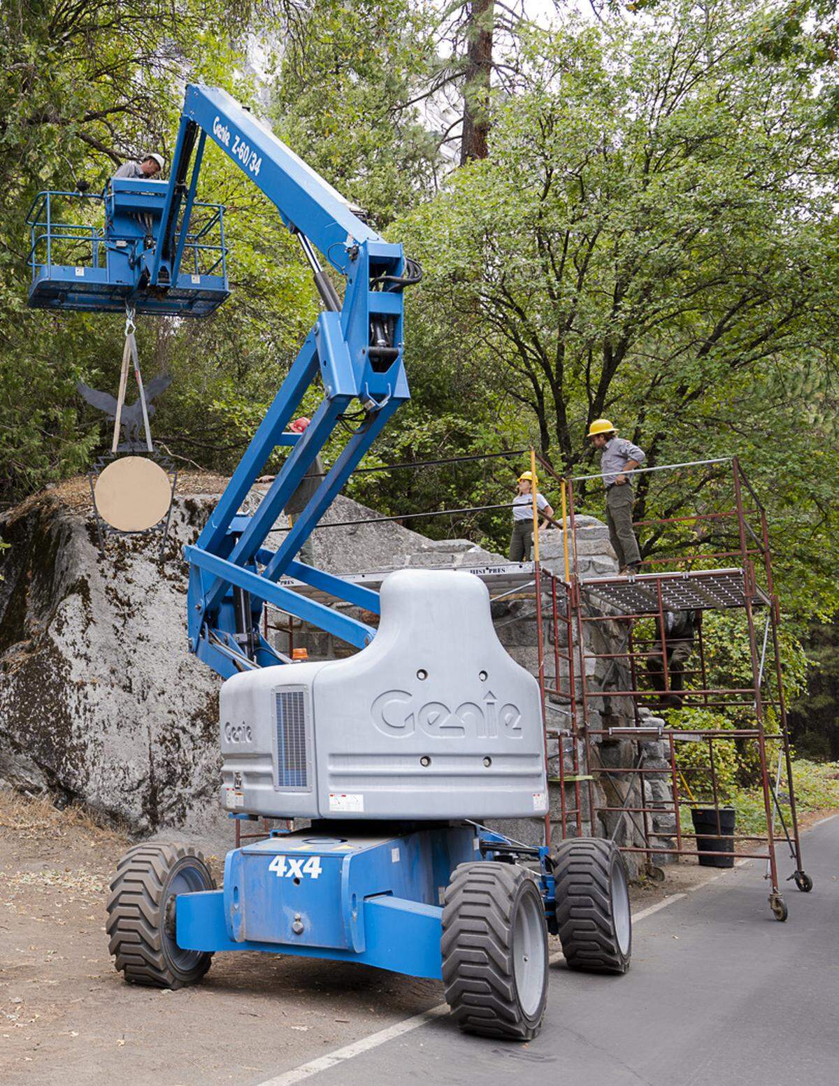 Members of Yosemite National Park’s historic preservation team install a new hotel sign on The Ahwahnee’s recently refurbished gatehouse. The original sign was stolen off that gatehouse in 2016.