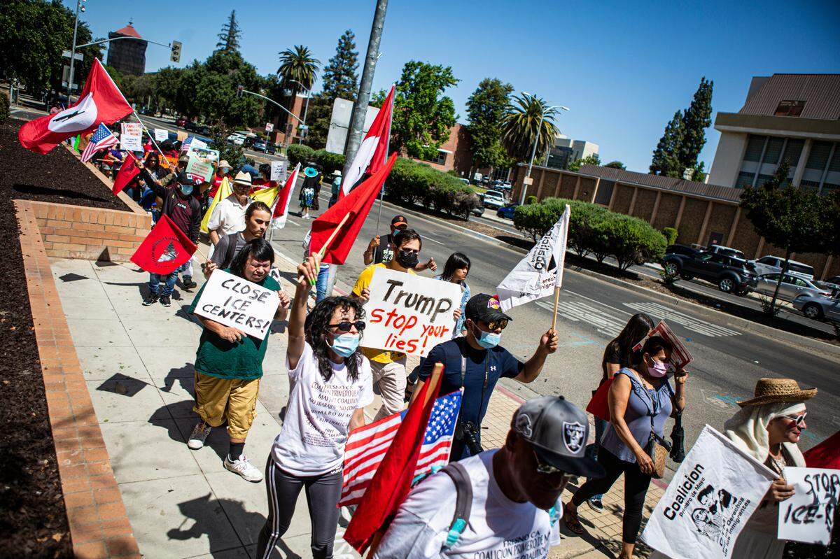 Marchers proceed west along Fresno Street near the Fresno County Jailhouse in downtown Fresno for the May Day Rally on Sunday, May 1, 2022.