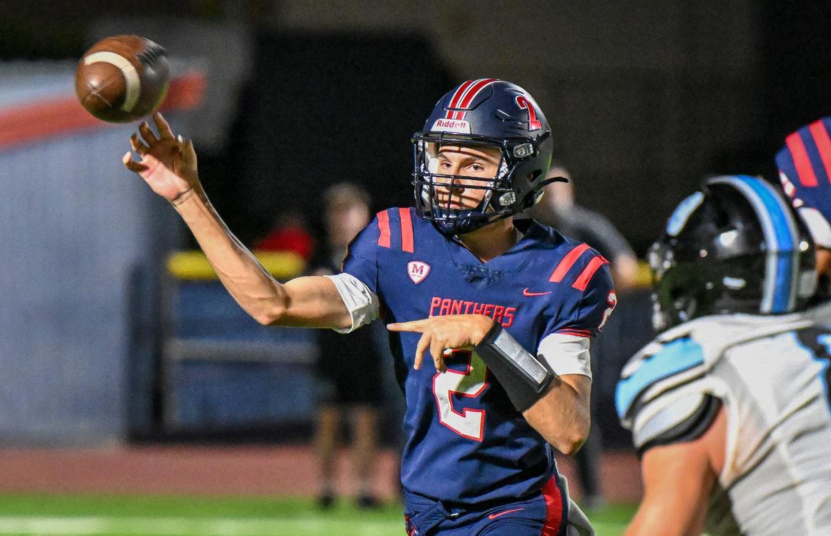 Memorial quarterback Colton Johnson throws against the Clovis North defense during their game at San Joaquin Memorial on Friday, Aug. 23, 2024.