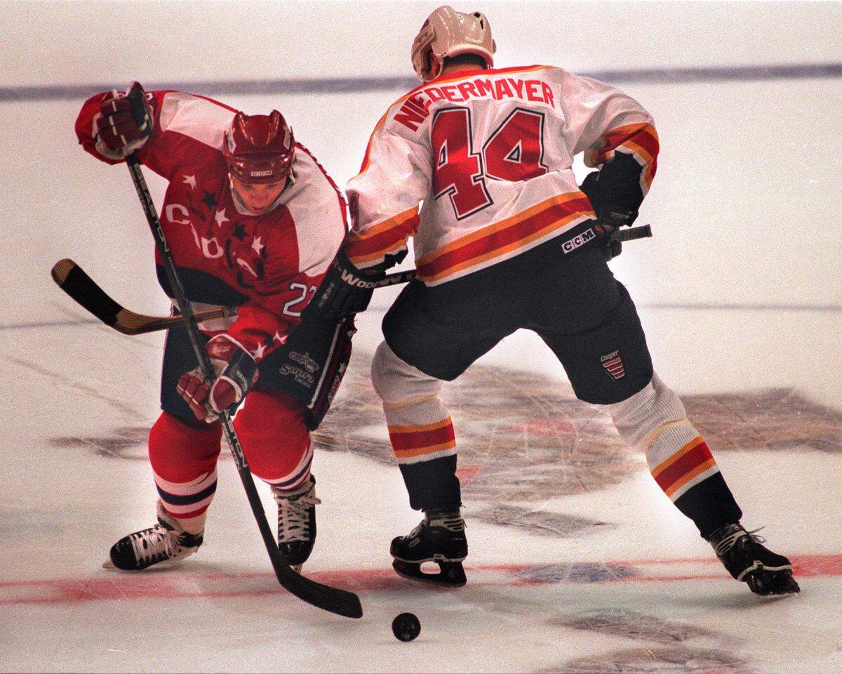 #23 Kevin Kaminski of the Washington Capitals and # 44 Rob Niedermayer of the Panthers going for the puck