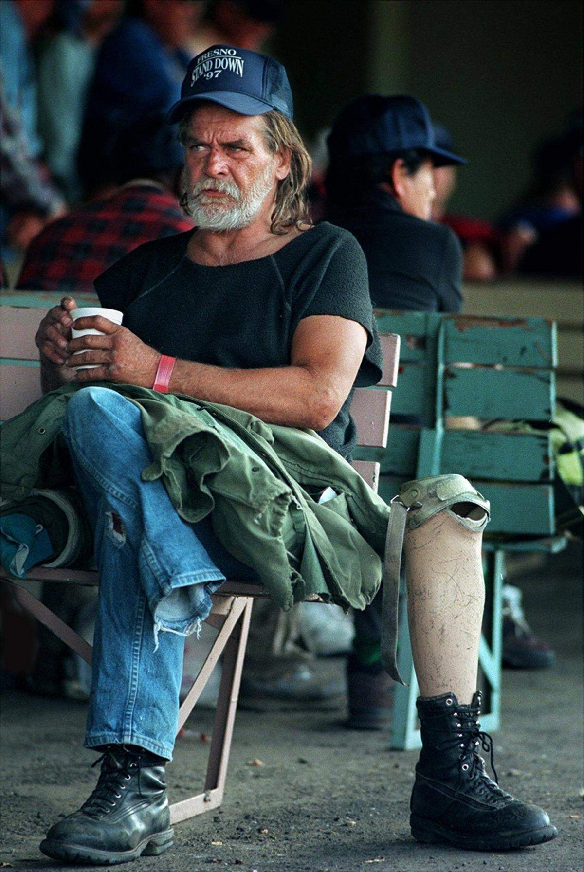 Bruce Ratushky, a homeless Vietnam War Army veteran, who lost his leg in the war, waits for lunch during a local Stand Down event in 1997. The program offered aid to homeless vets.