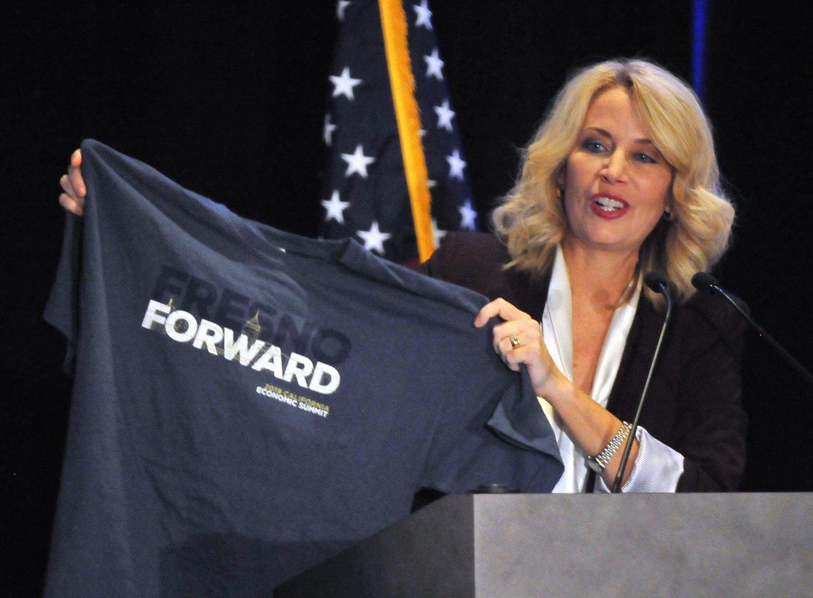 Ashley Swearengin, CEO of Central Valley Community Foundation, shows a t-shirt made for the 2019 California Economic Summit, during the kick-off of the event, Thursday morning, Nov. 7, 2019.
