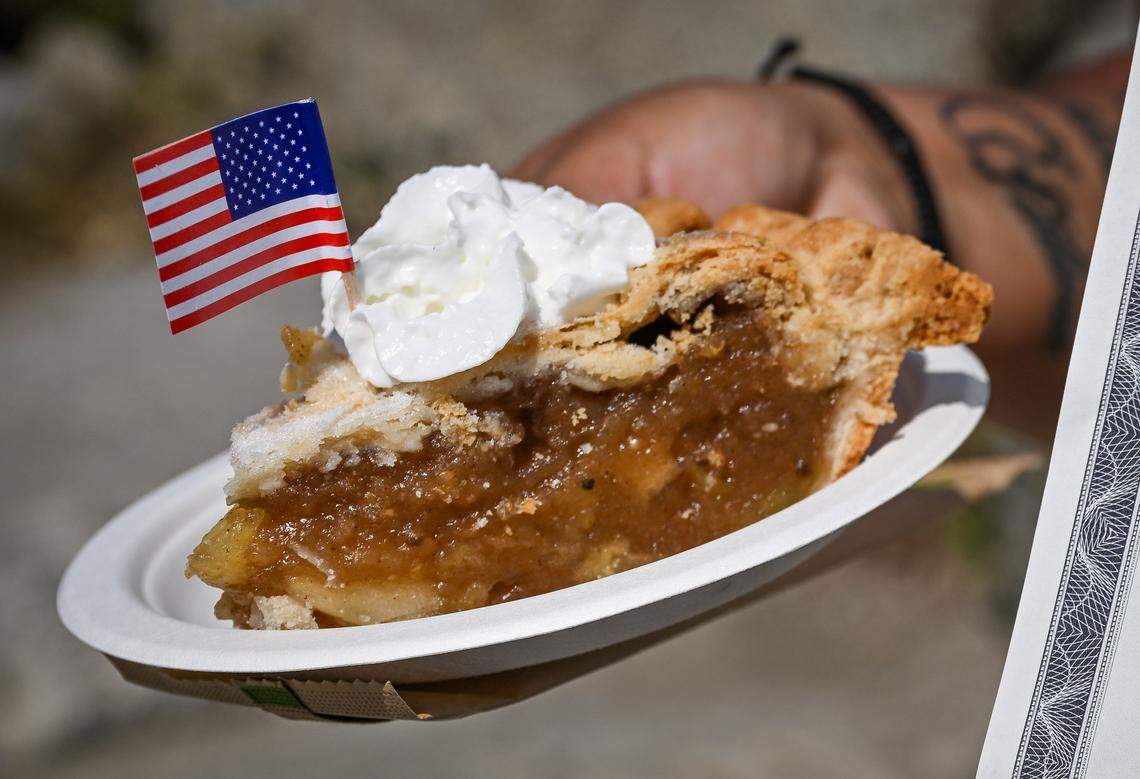 New citizen Erika Guadalupe Ramos Hernandez, an immigrant from Mexico and currently living in Selma, gets ready to enjoy a slice of apple pie after receiving here citizenship certificate during a naturalization ceremony held at Glacier Point in Yosemite National Park on Wednesday, Sept. 17, 2025. 