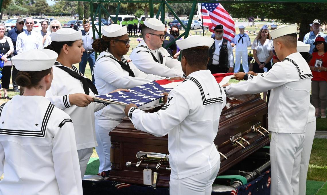 A naval honor guard detail folds the American flag that had draped the casket of Seaman 2nd Class Denver True “D.T.” Kyser, as he is laid to rest in a ceremony at Fresno Memorial Gardens Saturday afternoon, May 21, 2022 in Fresno. Kyser, 18 at the time, was assigned to and serving on the battleship USS Oklahoma when it was attacked by Japanese aircraft as it was moored at Ford Island, Pearl Harbor on Dec. 7, 1941.