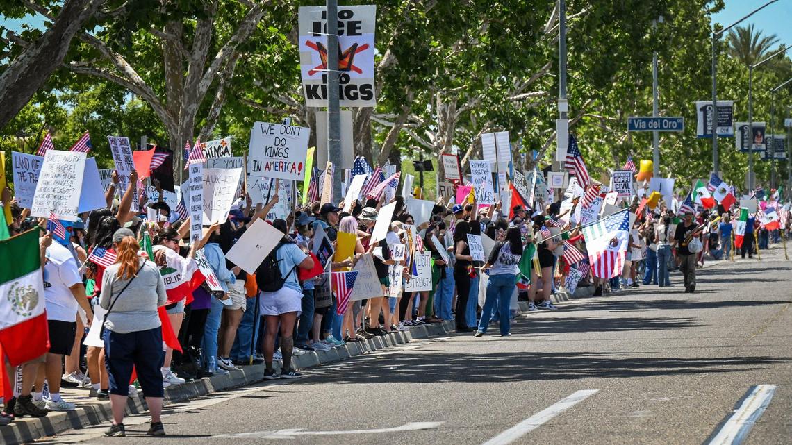 Hundreds of protestors line Blackstone Avenue at Nees near River Park shopping center during a no kings protest against President Donald Trump’s policies in Fresno on Saturday, June 14, 2025.