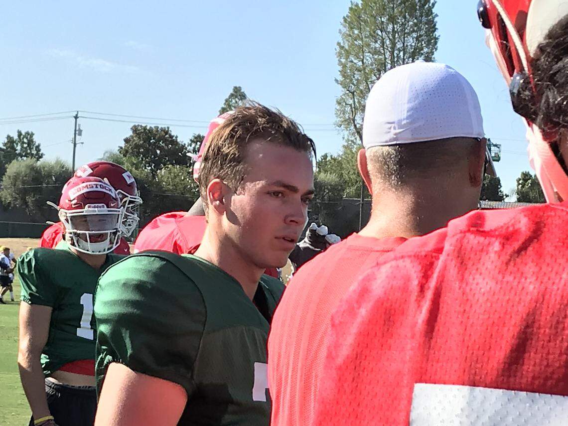 Washington transfer quarterback Jake Haener, center, listens to instructions during Fresno State football practice in September 2019, the day after he enrolled.