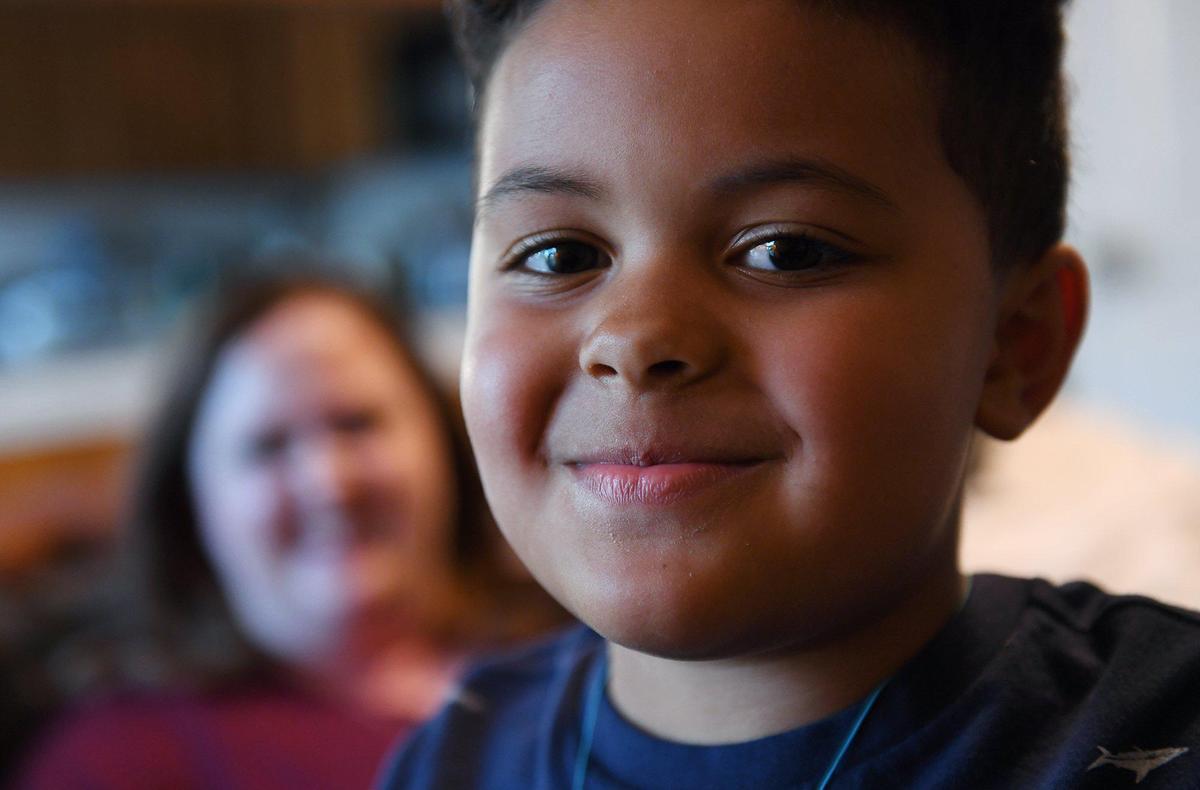 Bryce Moore, 5, poses with his parents Jennifer and Evan Moore at the family’s home Tuesday, Feb. 23, 2021 in Fresno. Bryce was diagnosed with MIS-C after he contracted COVID-19 in January.