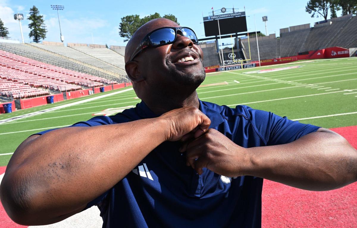 Tim Skipper smiles as he removes microphones after making his first appearance with the media as Fresno State’s interim head football coach at Valley Children’s Stadium Wednesday morning, July 24, 2024 in Fresno.