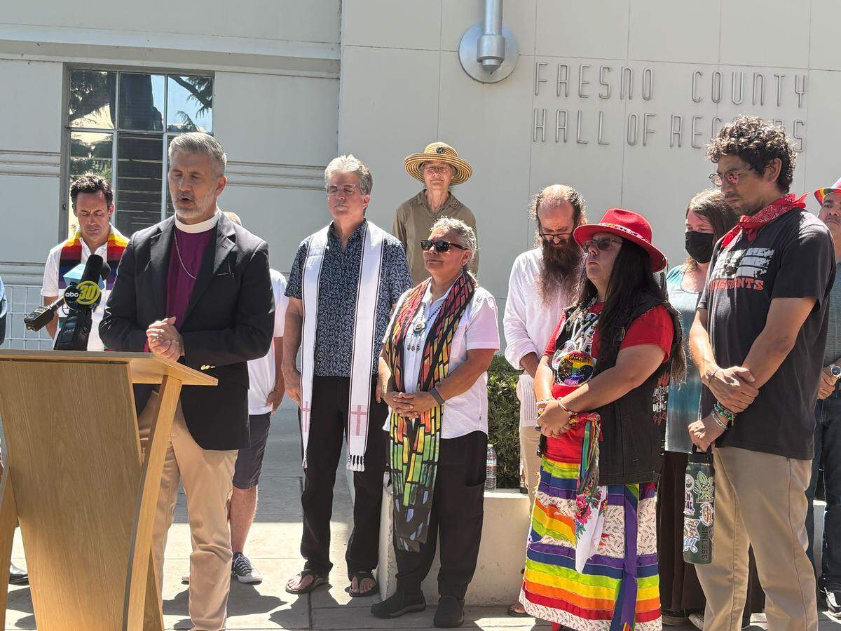 Supporters and members of the Fresno County LGBTQ+ community pray at a gathering Monday, May 11, 2026, to advocate for the Board of Supervisors to approve a request from library staff to participate in the Fresno Rainbow Pride event in June.