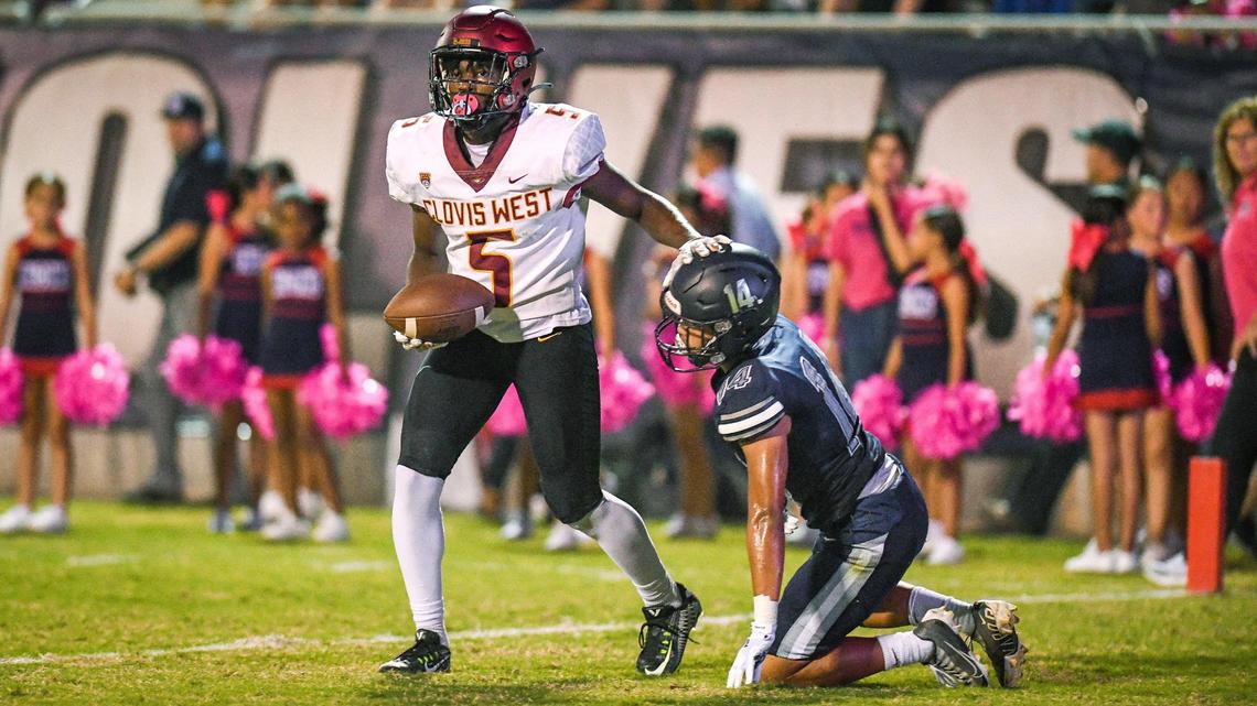 Clovis West wide receiver Marshel Sanders pats Clovis East defender Fresno Moua on the head after catching a touchdown pass in the end zone during the first half of their game at Lamonica Stadium on Friday, Oct. 7, 2022.