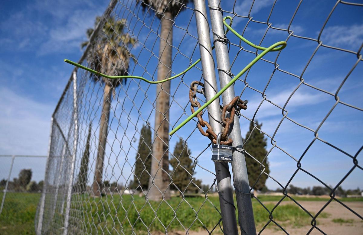 Fencing encircles a new 49-acre park being developed along Peach Avenue between Butler and Church avenues. Photographed Wednesday, Feb. 19, 2025, in Fresno.