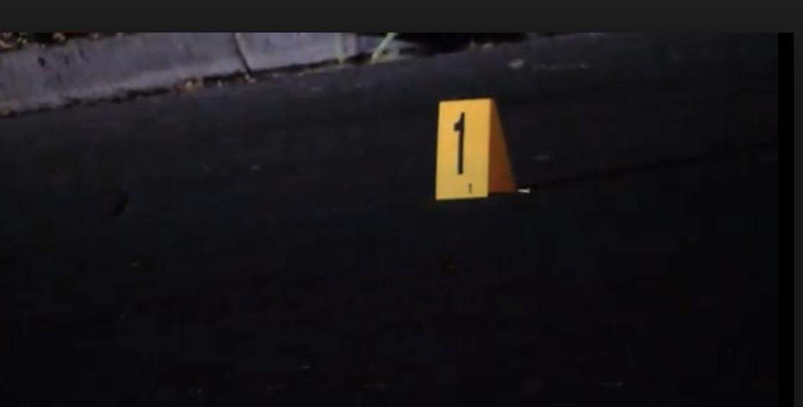 Evidence marker shows a shell casing in the roadway after a teen was shot on Saturday, May 10, 2025.