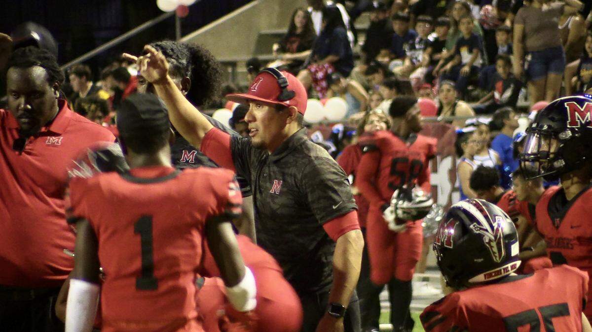 File photo of McLane coach Andrew Pancotti discusses a play during a timeout of the Highlanders’ 49-13 victory over Immanuel in Fresno, California on Thursday, Sept. 7, 2023.