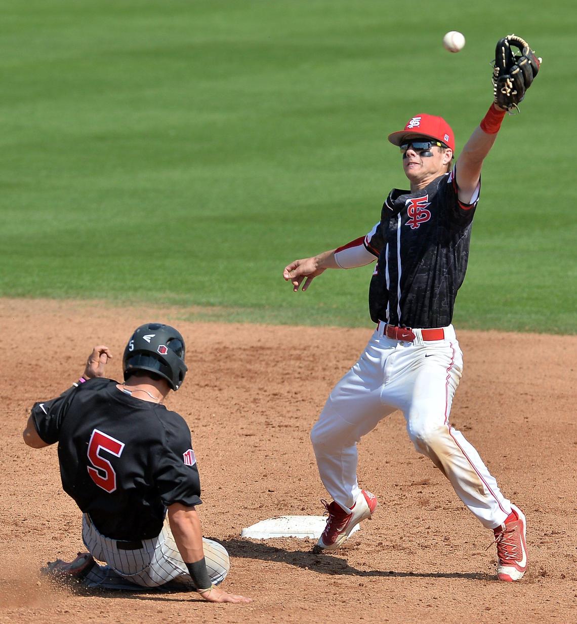 Fresno State shortstop Korby Batesole reaches for a throw as UNLV's Justin Jones, left, slides into second base in a 2016 game at Pete Beiden Field in Fresno. Batesole this season is batting .312 for the Bulldogs.