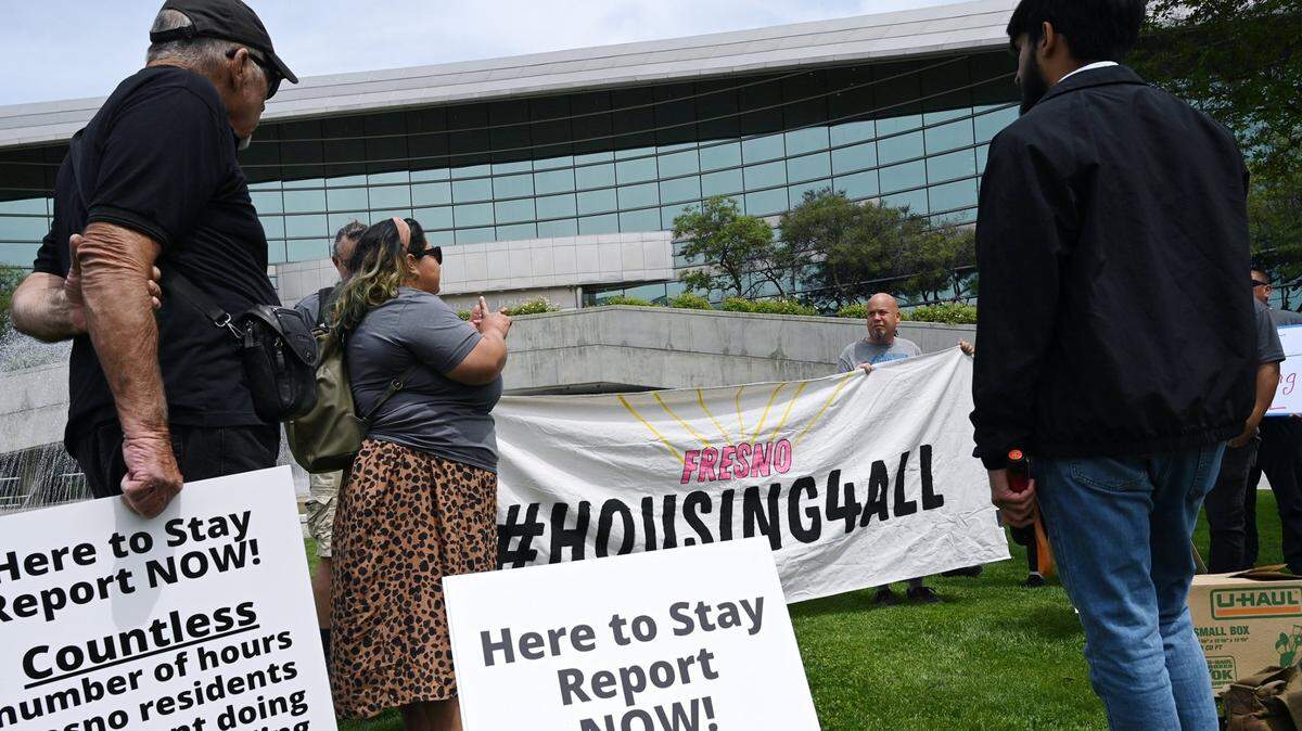 Demonstrators gather outside of Fresno City Hall before the start of a special City Council meeting last April to consider Fresno’s housing plans.