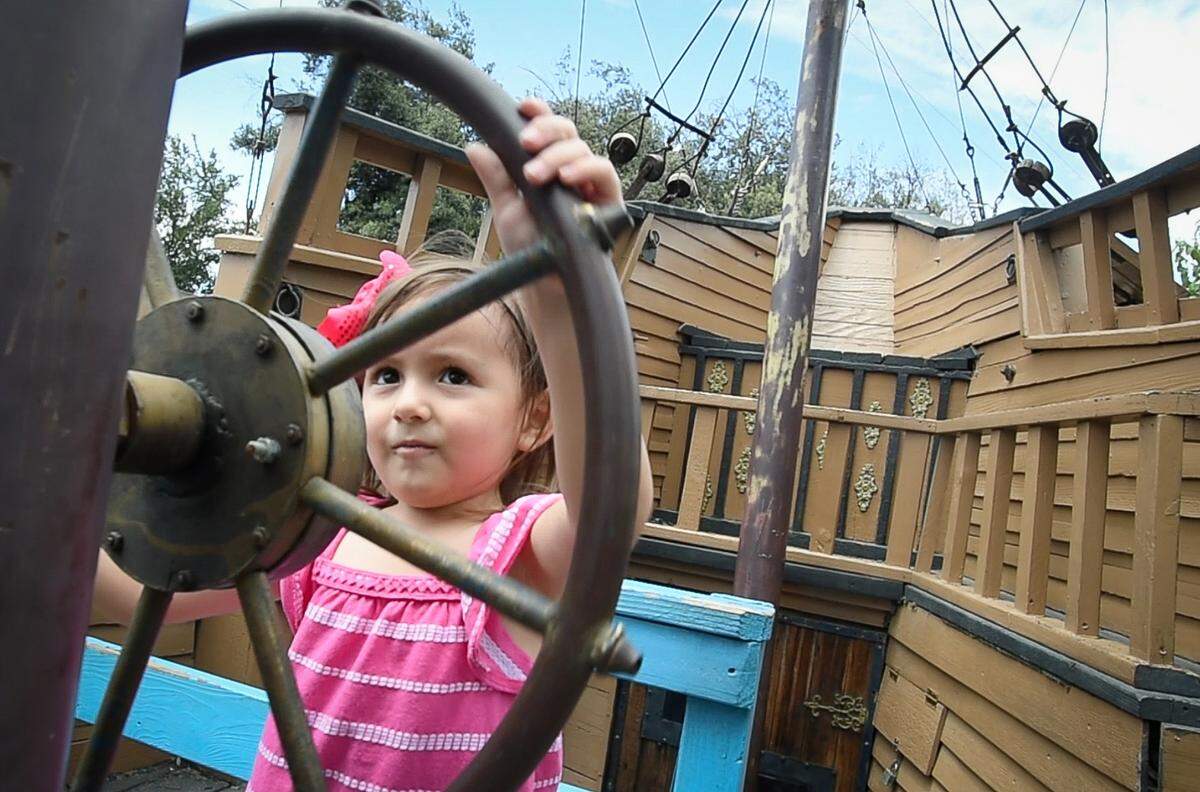 3 1/2-year-old Riley Ward steers GulliverÕs Pirate Ship at Storyland.