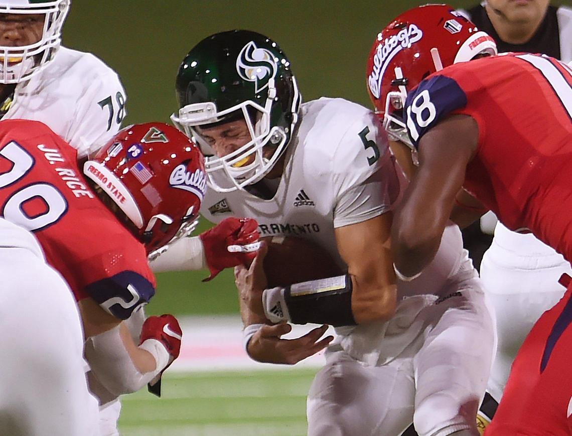 Sacramento State quarterback Kevin Thomson, center, is sacked with Fresno State’s Justin Rice, left, and Isaiah Johnson, right, Saturday, Sept 21, 2019 in Fresno.