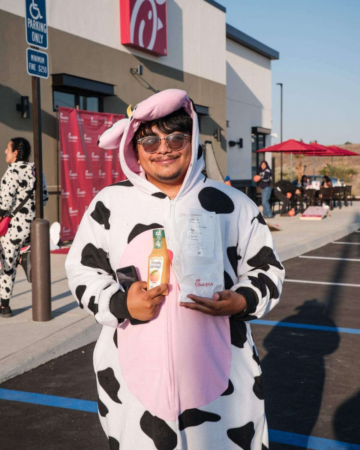 A Chick-fil-A East Cartmill’s customer dressed in cow spots on the restaurant’s opening day May 7, 2026 in Tulare.