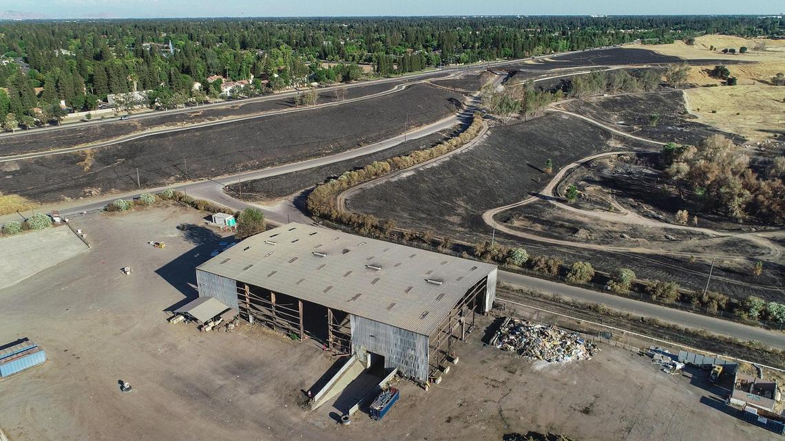 A drone photo shows the Republic Services recycling center on Rice Road near Friant Road just north of Fresno on Wednesday, June 23, 2021. Recent fires around the recycling center have blackened a number of acres of the San Joaquin River bottoms area and the Eaton Trail.