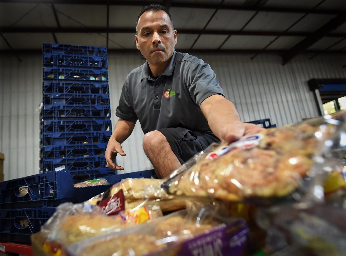 Central California Food Bank warehouse supervisor Joe Espinosa sorts donated bread products on Wednesday Jan. 9, 2019.