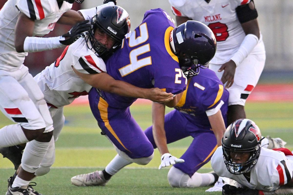 McLane’s Alexis Conseco, left, tackles Fresno’s Ayden Yang in a game Thursday, Sept. 14, 2023 in Fresno.