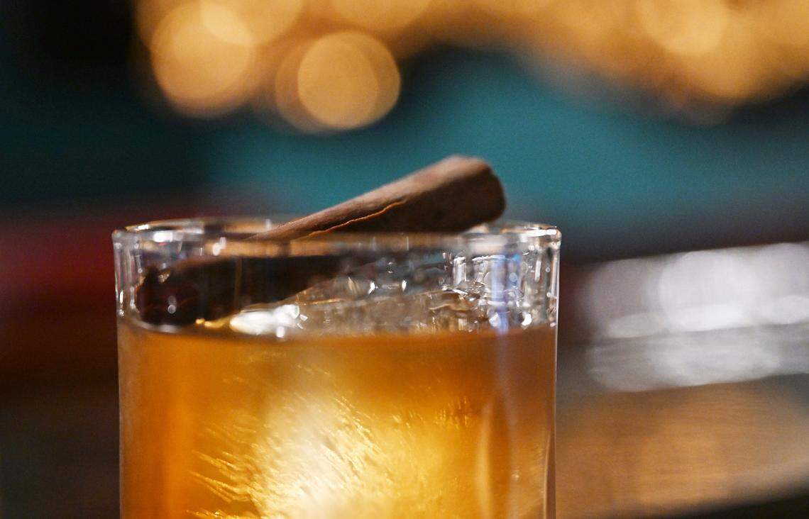 A cinnamon stick tops the Churro Old Fashioned cocktail at the new Electric Olive cocktail bar in Fresno's Tower District Thursday, Nov. 20, 2025 in Fresno.