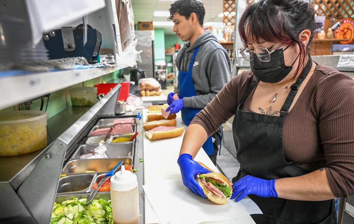 Tabatha Hernandez and Anthony Martinez prepare sandwiches for the lunch crowd at Piemonte’s Deli in Fresno’s Tower District on Thursday, Jan. 9, 2025. Deli owners Nancy and Neil Eberwein are in the process of selling the business to the store manager Madison Lindsey Martinez and her mother, Jules, after 24 years of running it.