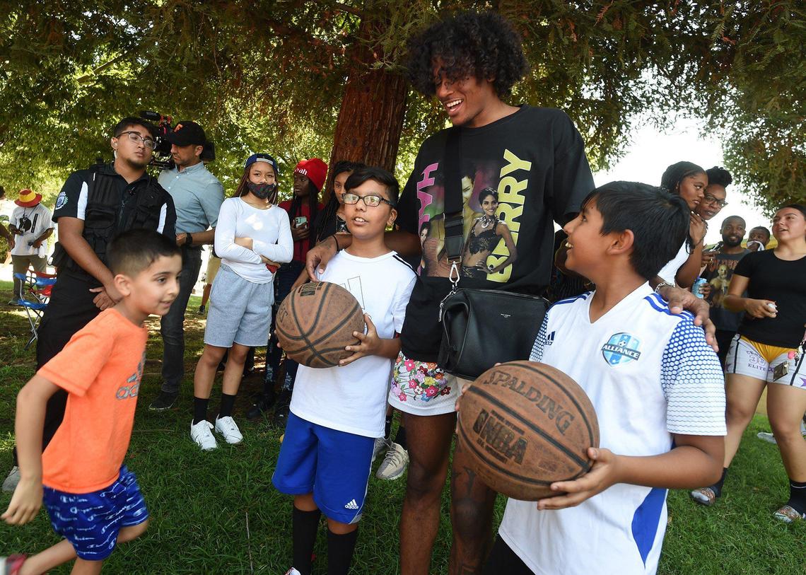 Jalen Green, NBA lottery pick, visits fans Gurbathe Hayer, 10, center, and Hartaj Khatra, 10, right, before the dedication of the basketball court, he renovated, dubbed “The Cage,” at Koligian Park, July 17, 2021. It has been a dream of his to give back to his hometown by renovating the court that ignited his love for the game.