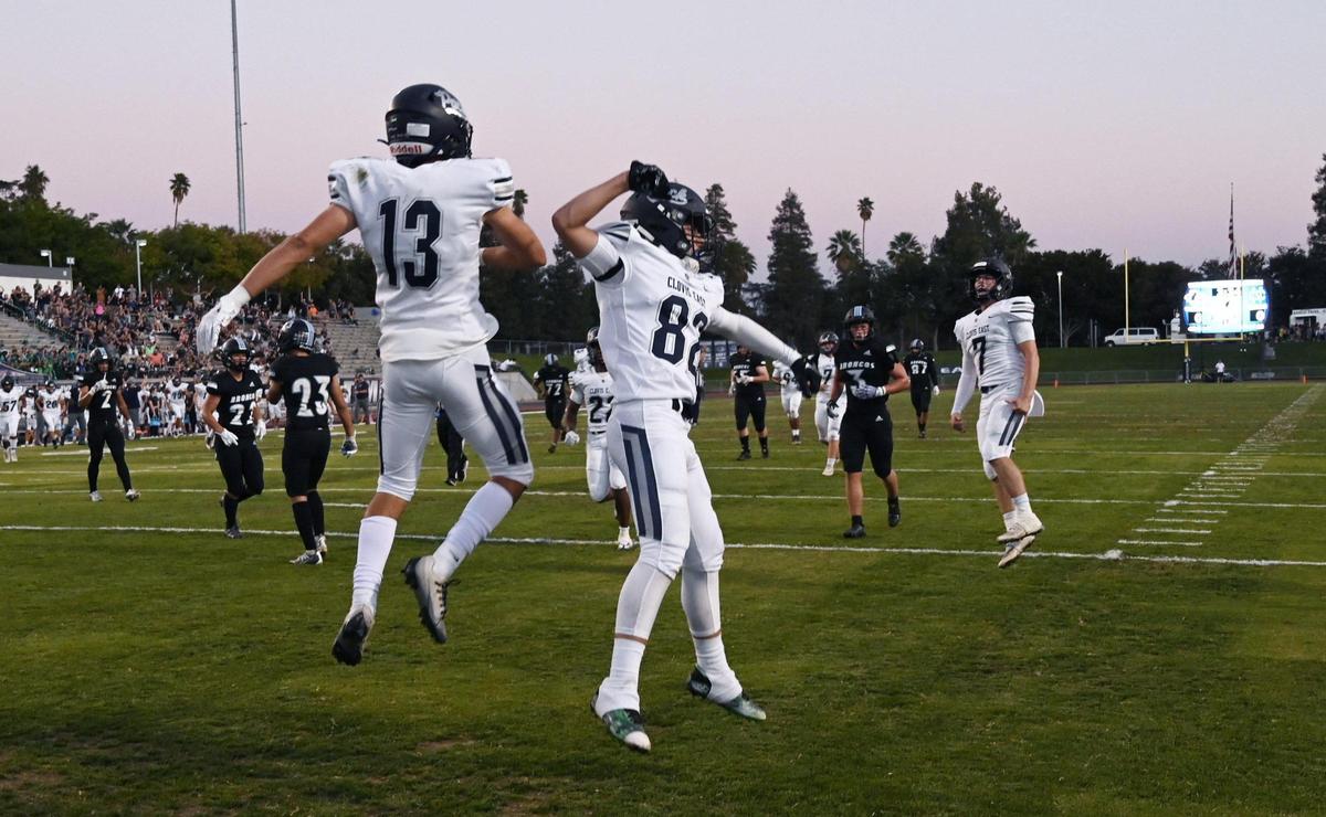 Clovis East’s Carson Sandoval, left, and Tristan Kircher, right, celebrate Sandoval’s touchdown against Clovis North Friday, Sept. 30, 2022 in Clovis. Clovis East came from behind to win 39-35.