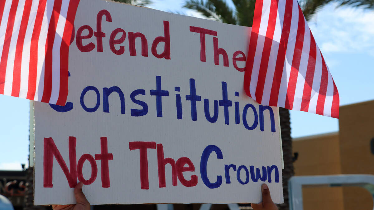 A protester carries a sign during the No Kings Rally held June 14, 2025 at Riverpark Shopping Center.