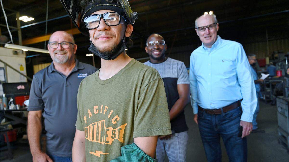 Carlos Martinez-Ramos, second from left, is seen with Bruce Ketch, general manager at Career Nexus, left, Timothy Lowe, internship manager at Career Nexus, second from right, and Kurt Madden, far right, CEO of Career Nexus, at United Western Industries, where Martinez-Ramos works as a welder in Fresno. Carlos graduated from a work training program supported by Career Nexus, which placed him at United Western. The company was so impressed with Martinez-Ramos’ work, it hired him full-time.
