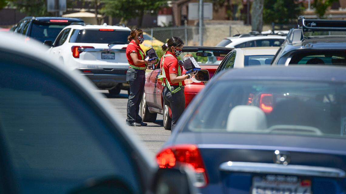 Chick-fil-A employees take orders from customers lined up in the drive-thru line. A 2021 SeeLevel HX report on restaurant drive-thrus found that service times are slower compared to last year. Data also show customer orders were less accurate.