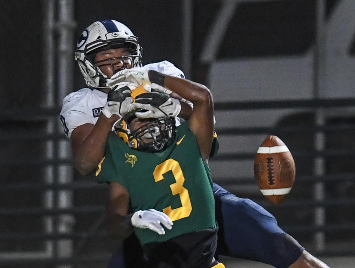 Kingsburg’s Kenyon Simpson, bottom, is unable to make the grab as Central Valley Christian’s Jaeden Moore breaks up the pass in the end zone during their game at Kingsburg on Friday, Oct. 14, 2022.