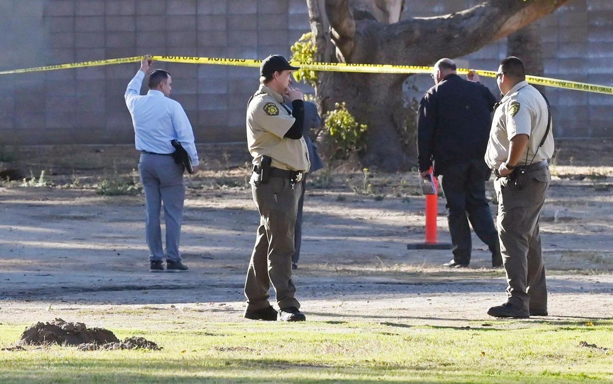 Investigators arrive behind Storyland in Roeding Park Thursday, Nov. 21, 2024 in Fresno. Police said a man died of a heart attack under suspicious circumstances.