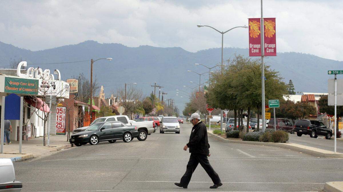 A man walks across Park Boulevard in Orange Cove in this 2013 photo.
