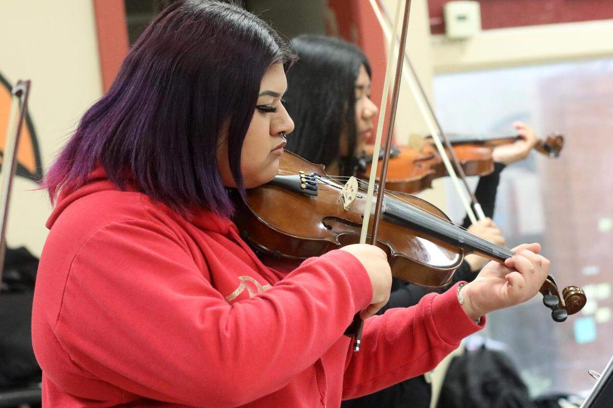 Orosi High School Mariachi Cardenal violin player Samantha Alejandro during the mariachi class on Wednesday, March 15, 2023.